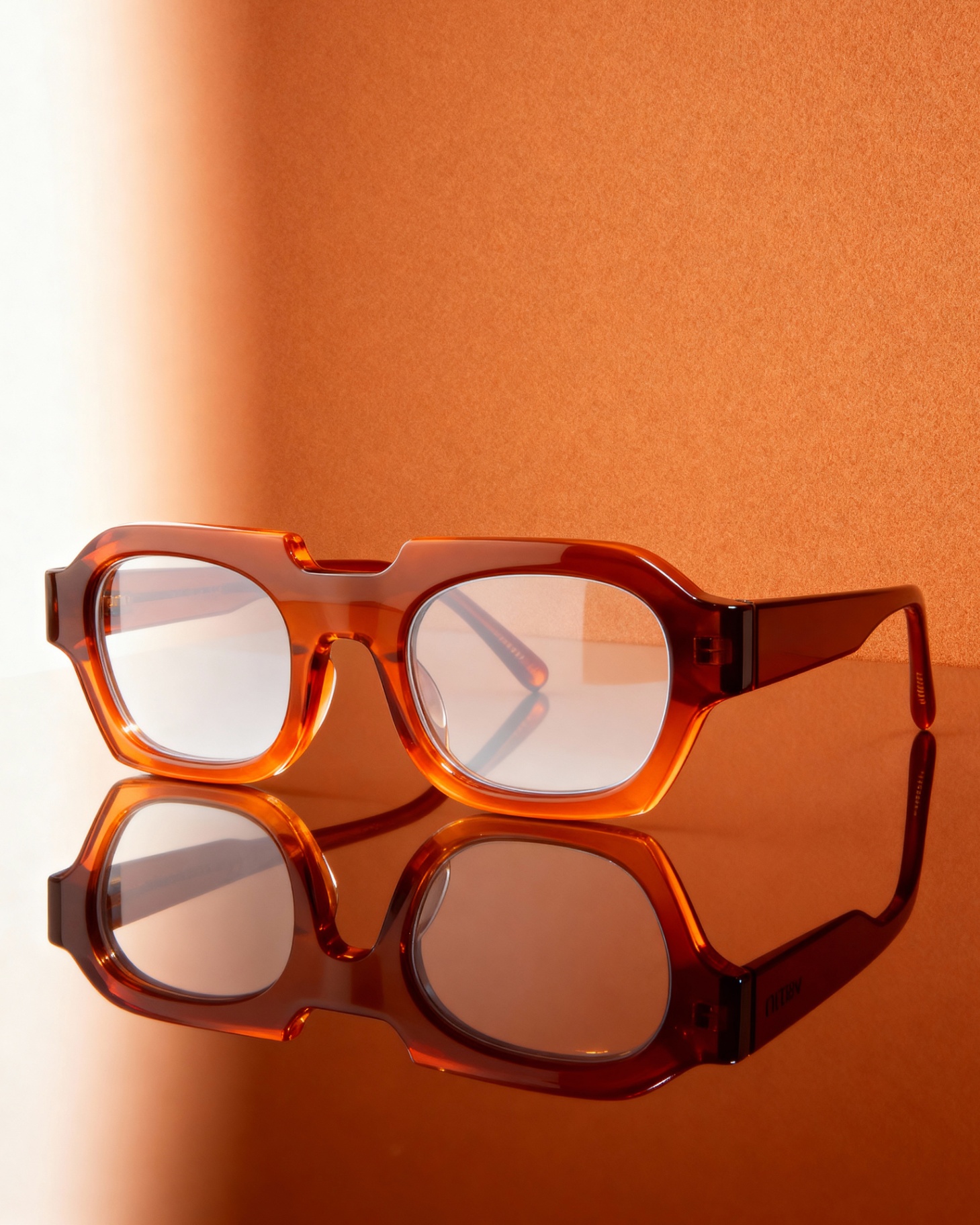 Studio still life — amber square frame with reflection