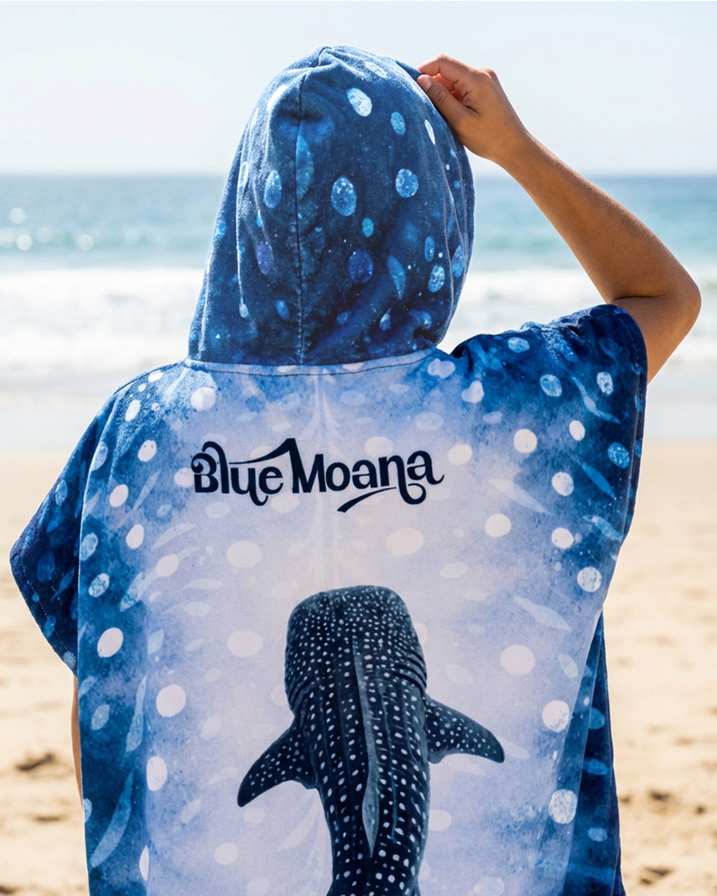 Back view of whaleshark hooded poncho with Blue Moana wordmark