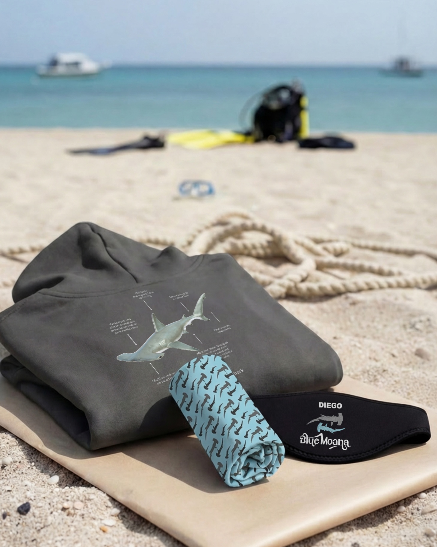Hammerhead hoodie flat-lay with mask strap and buff on the beach
