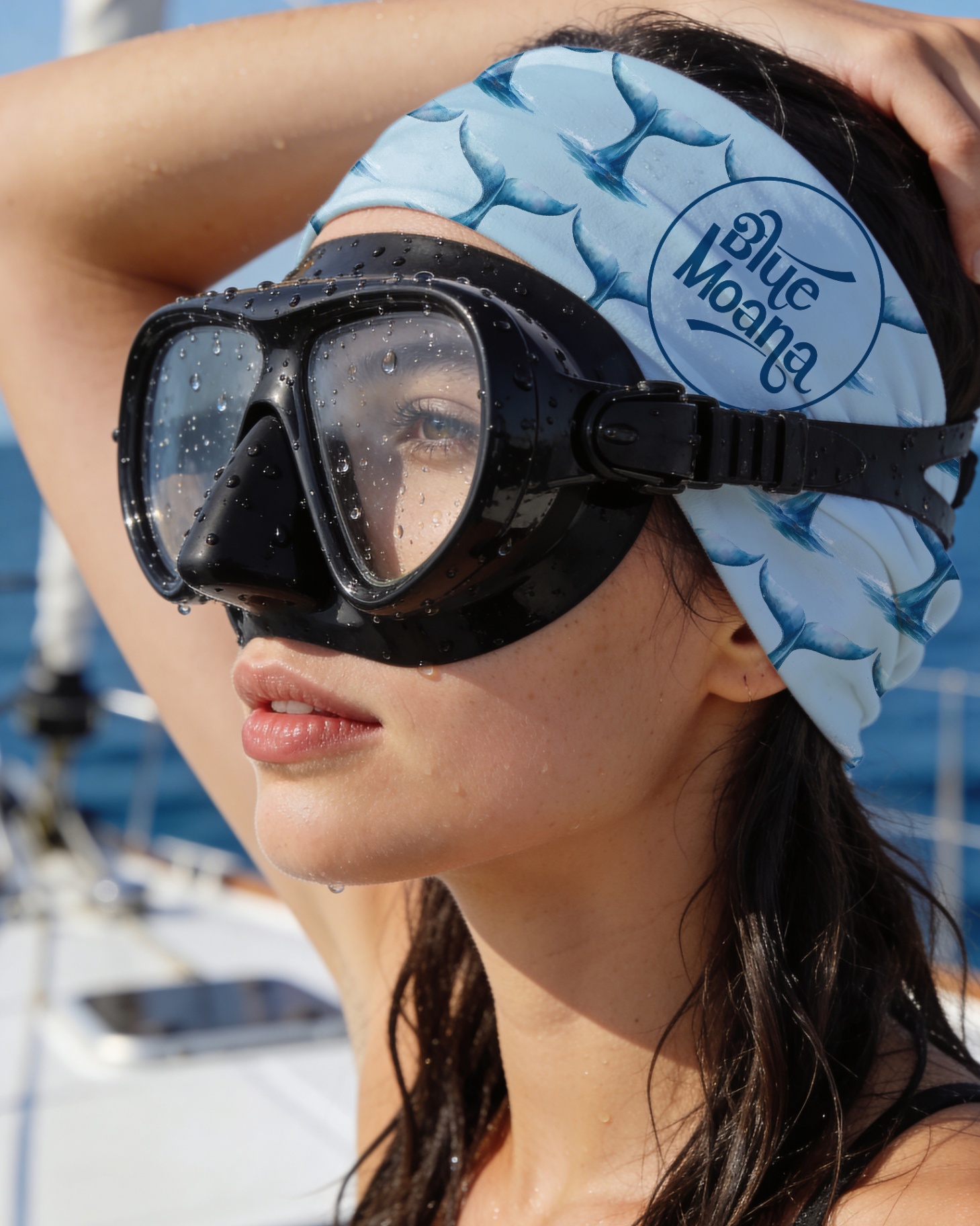 Diver on yacht wearing light blue whaletail buff