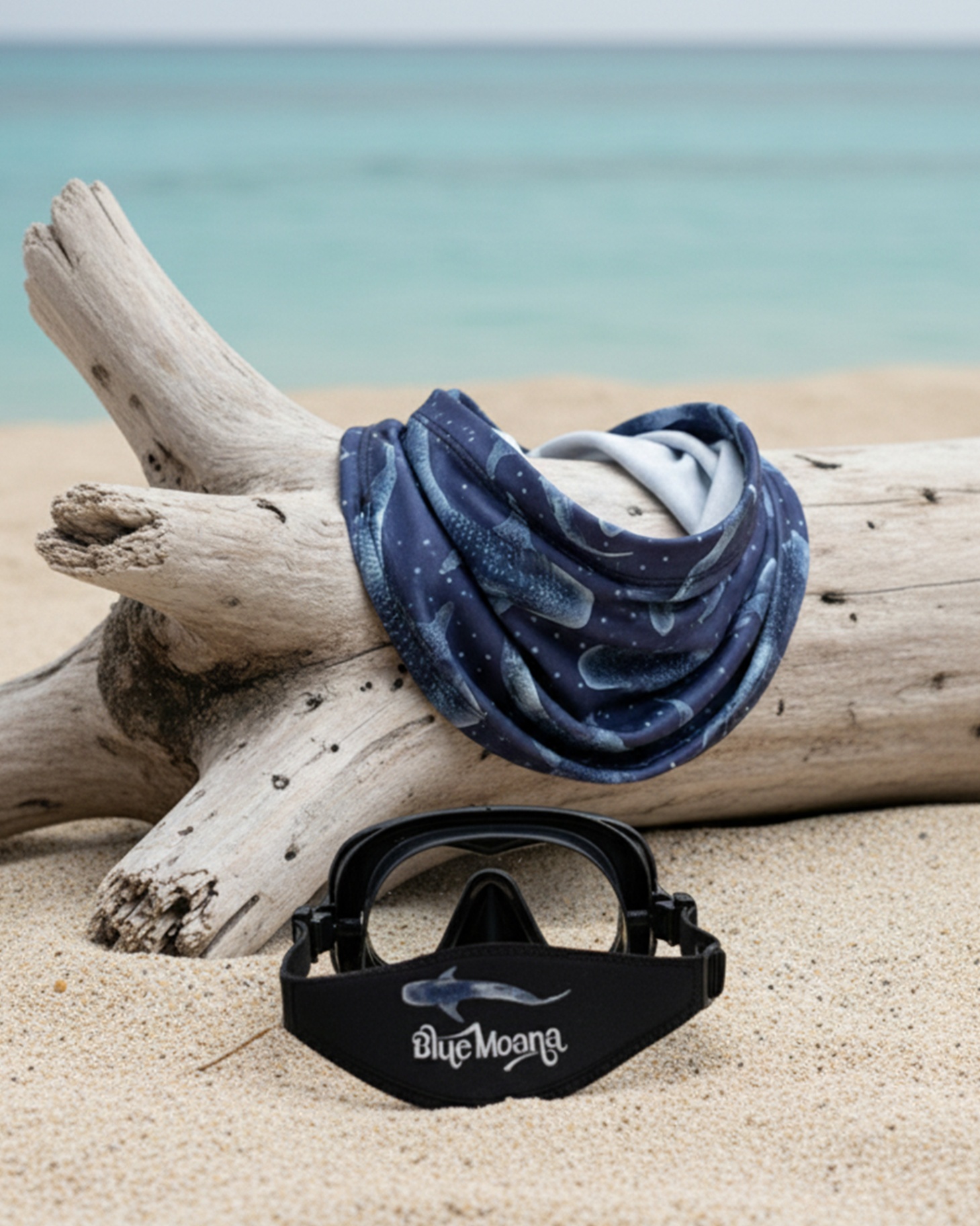 Whaleshark buff and branded mask strap on driftwood still life
